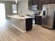 Modern kitchen with stainless steel appliances and an island at 8073 Cherrystone St, Leesburg, FL 34748