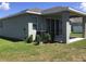 Well-maintained house exterior with covered patio and AC unit at 8073 Cherrystone St, Leesburg, FL 34748