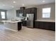 Modern kitchen with stainless steel appliances and an island at 8073 Cherrystone St, Leesburg, FL 34748