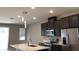 Modern kitchen with stainless steel appliances and an island at 8073 Cherrystone St, Leesburg, FL 34748