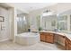 Elegant bathroom with a large soaking tub, double vanity, and shower at 25515 Hawks Run Ln, Sorrento, FL 32776