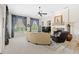 Spacious living room featuring a curved sofa, fireplace, and large windows at 25515 Hawks Run Ln, Sorrento, FL 32776