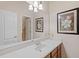 Light and bright bathroom with a vanity and marble countertop at 25515 Hawks Run Ln, Sorrento, FL 32776