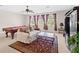Game room with pool table, seating area, and large windows at 25515 Hawks Run Ln, Sorrento, FL 32776