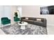 Elegant living room featuring a plush sofa and accent chairs, coffee table and large area rug at 7252 Oakmoss Loop, Davenport, FL 33837