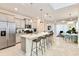 Modern kitchen with granite countertops, stainless steel appliances, and an island at 7252 Oakmoss Loop, Davenport, FL 33837