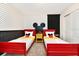 Mickey Mouse themed bedroom with twin beds and polka dot walls at 7252 Oakmoss Loop, Davenport, FL 33837