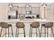 Modern kitchen with gray cabinets, granite island and stainless steel appliances at 7252 Oakmoss Loop, Davenport, FL 33837