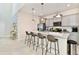 Modern kitchen with gray cabinets, granite island and stainless steel appliances at 7252 Oakmoss Loop, Davenport, FL 33837