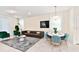 Open living and dining area with modern furniture and decor at 7252 Oakmoss Loop, Davenport, FL 33837