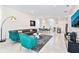 Open floor plan showcasing living, dining, and kitchen areas with modern decor at 7252 Oakmoss Loop, Davenport, FL 33837