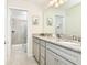 Bathroom with double vanity, granite countertop, and shower at 7252 Oakmoss Loop, Davenport, FL 33837