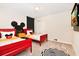 Mickey Mouse themed bedroom with twin beds and polka dot walls at 7252 Oakmoss Loop, Davenport, FL 33837