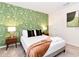 Bedroom with a king-size bed, patterned wallpaper, and nightstands at 7252 Oakmoss Loop, Davenport, FL 33837