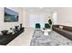 Modern living room with large TV, comfortable seating and stylish decor at 7252 Oakmoss Loop, Davenport, FL 33837