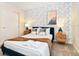 Bedroom with a queen-size bed, floral wallpaper, and nightstands at 7252 Oakmoss Loop, Davenport, FL 33837