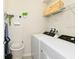 Laundry room with washer, dryer, and storage shelves at 7252 Oakmoss Loop, Davenport, FL 33837