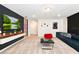 Finished basement with a large TV, comfortable seating, and a game area at 7252 Oakmoss Loop, Davenport, FL 33837