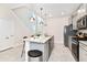 Modern kitchen with gray cabinets, granite island and stainless steel appliances at 7252 Oakmoss Loop, Davenport, FL 33837