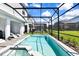 Relaxing screened pool and spa with plenty of lounge chairs at 7252 Oakmoss Loop, Davenport, FL 33837