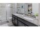 Bathroom with double sinks, granite countertop, and shower at 9076 Hazard St, Davenport, FL 33896