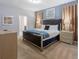 Main bedroom with king-size bed, plush carpeting, and ensuite bathroom at 9076 Hazard St, Davenport, FL 33896