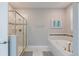 Bathroom with soaking tub, shower, and grey tile at 9076 Hazard St, Davenport, FL 33896