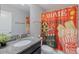 Bathroom with granite countertop, dark vanity, and movie-themed shower curtain at 9076 Hazard St, Davenport, FL 33896