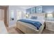 Main bedroom with king-size bed, blue blanket, and en-suite bathroom at 9076 Hazard St, Davenport, FL 33896