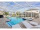 Inviting pool and spa with screened enclosure and lounge chairs at 9076 Hazard St, Davenport, FL 33896