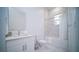 Clean bathroom with white vanity and marble tile at 387 Famagusta Dr, Davenport, FL 33896