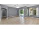 Living area with gray walls, tile floors, and sliding glass doors to patio at 9220 Hidden Stream Ct, Orlando, FL 32825