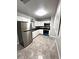 Modern kitchen with stainless steel appliances and tile flooring at 520 Avenue L Se, Winter Haven, FL 33880