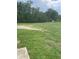 Large grassy backyard with a dirt patch and trees in the background at 2135 Sw 156Th Pl, Ocala, FL 34473