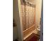 Bathroom with shower/tub combo and patterned curtain at 2135 Sw 156Th Pl, Ocala, FL 34473
