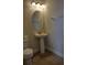 Small bathroom with pedestal sink, toilet and oval mirror at 601 Lasso Dr, Kissimmee, FL 34747