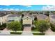 Aerial view of a two-story house with a gray garage door at 601 Lasso Dr, Kissimmee, FL 34747