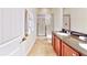 Bathroom with double sinks, shower, and granite countertop at 601 Lasso Dr, Kissimmee, FL 34747