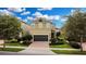 Two-story house with a two-car garage and landscaped yard at 601 Lasso Dr, Kissimmee, FL 34747