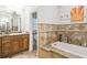 Bathroom with soaking tub, granite countertop and walk-in shower at 4600 Nebraska Ave, Sanford, FL 32771