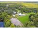 Aerial view of a large property with a barn, house, and lush green landscape at 4600 Nebraska Ave, Sanford, FL 32771