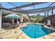 Inviting pool area with covered patio, stone deck, and lush landscaping at 4600 Nebraska Ave, Sanford, FL 32771