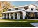White barn with black trim and several horse stalls at 4600 Nebraska Ave, Sanford, FL 32771