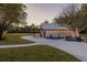 White barn with black accents, string lights, and a spacious paved driveway at 4600 Nebraska Ave, Sanford, FL 32771