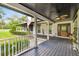 Front porch entrance with a wooden door and white railings at 4600 Nebraska Ave, Sanford, FL 32771