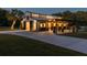 Well-lit white barn with black trim, a large metal awning, and ample parking at 4600 Nebraska Ave, Sanford, FL 32771