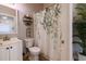 Bathroom with a floral shower curtain and white vanity at 4600 Nebraska Ave, Sanford, FL 32771