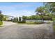 Long driveway entrance to the estate with a white fence and landscaping at 4600 Nebraska Ave, Sanford, FL 32771