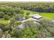 Aerial view of a property with a main house, barn and expansive green pastures at 4600 Nebraska Ave, Sanford, FL 32771