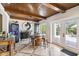 Home bar with wine cooler, barrel-top table, and patio access at 4600 Nebraska Ave, Sanford, FL 32771